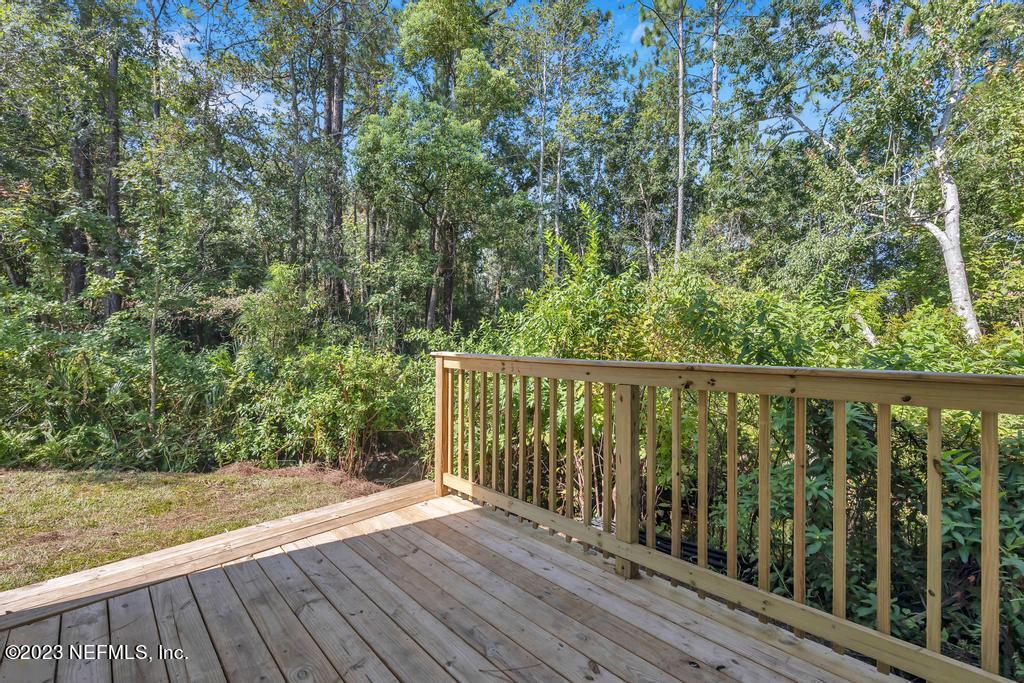 3666 Eunice Road Jacksonville, FL 32250 - Photo 6 of 32 a balcony with wooden floor and fence