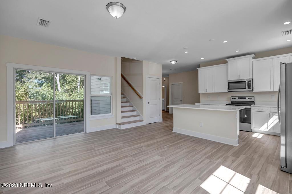 3666 Eunice Road Jacksonville, FL 32250 - Photo 8 of 32 a view of kitchen with stainless steel appliances wooden floor and window