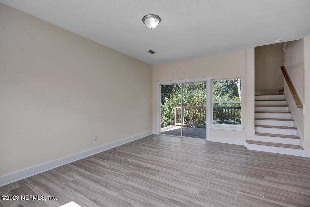 3666 Eunice Road Jacksonville, FL 32250 - Photo 9 of 32 a view of an empty room with wooden floor and window