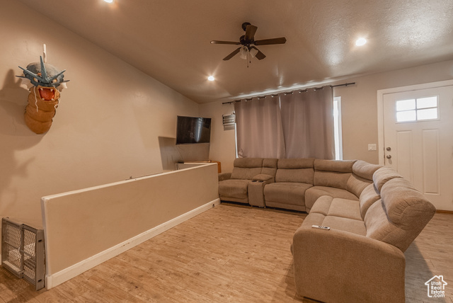 660 East 400 North Spring City, UT 84662 - Photo 2 of 16 Living room with vaulted ceiling, wood finished floors, baseboards, ceiling fan, and recessed lighting