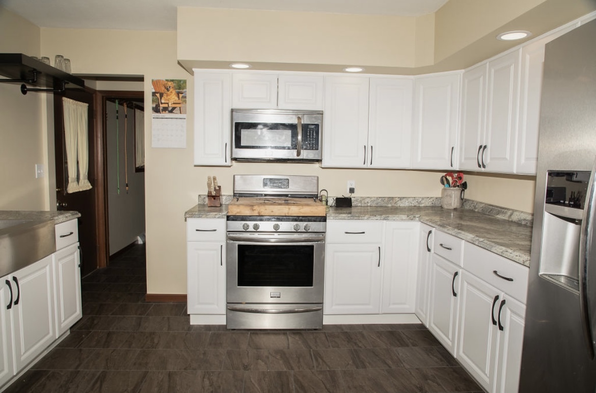 1004 Stockholm Road Paxton, IL 60957 - Photo 7 of 12 a kitchen with stainless steel appliances granite countertop a stove a refrigerator and a microwave