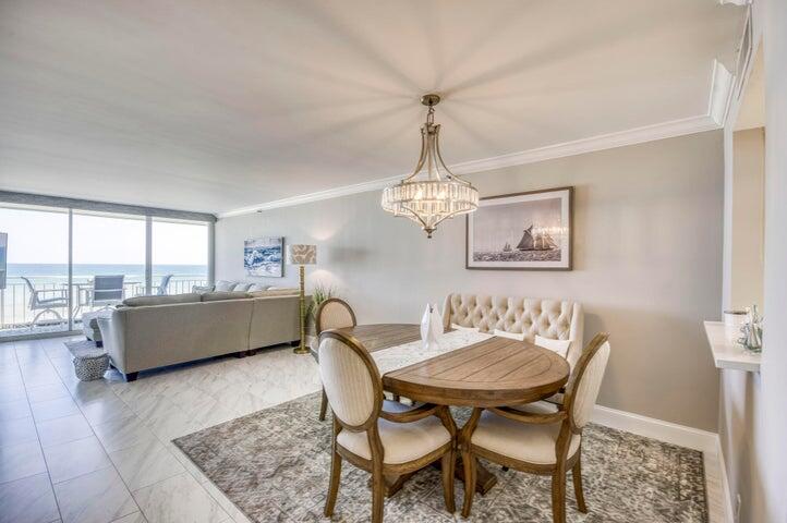 9600 South Ocean Drive, Unit 306 Jensen Beach, FL 34957 - Photo 14 of 36 a dining room with furniture a chandelier and wooden floor