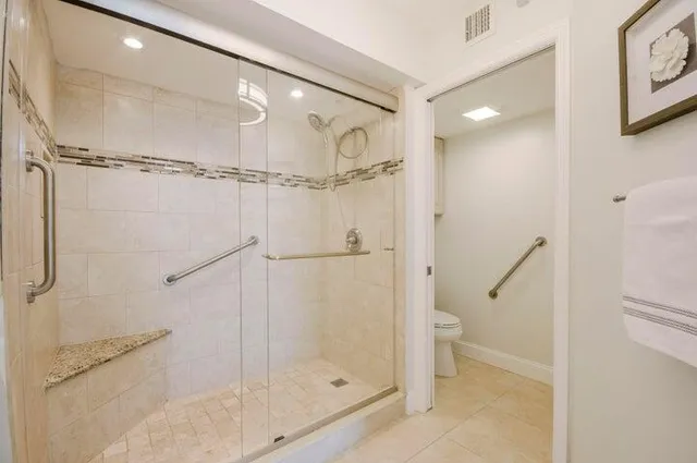 a bathroom with a glass shower door