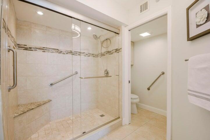 9600 South Ocean Drive, Unit 306 Jensen Beach, FL 34957 - Photo 24 of 36 a bathroom with a glass shower door