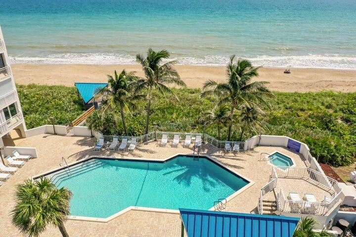 9600 South Ocean Drive, Unit 306 Jensen Beach, FL 34957 - Photo 30 of 36 a view of a swimming pool with a yard