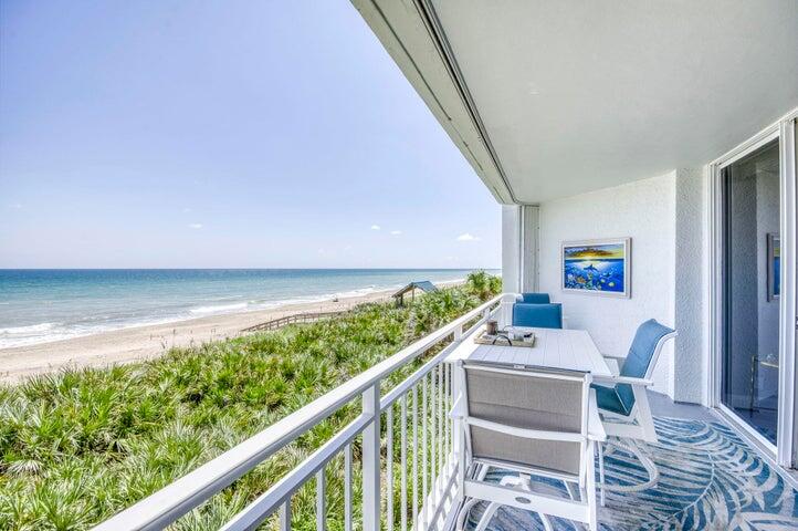 9600 South Ocean Drive, Unit 306 Jensen Beach, FL 34957 - Photo 4 of 36 a balcony with wooden floor and furniture
