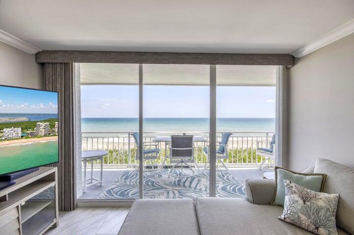 9600 South Ocean Drive, Unit 306 Jensen Beach, FL 34957 - Photo 6 of 36 a living room with furniture and a floor to ceiling window