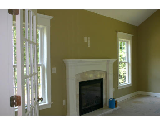 87 Lancaster County Road Harvard, MA 01451 - Photo 3 of 15 a living room with a fireplace and a window