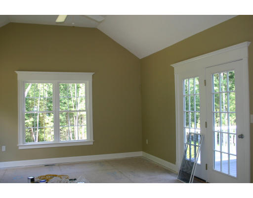 87 Lancaster County Road Harvard, MA 01451 - Photo 6 of 15 a view of an empty room with wooden floor and a window