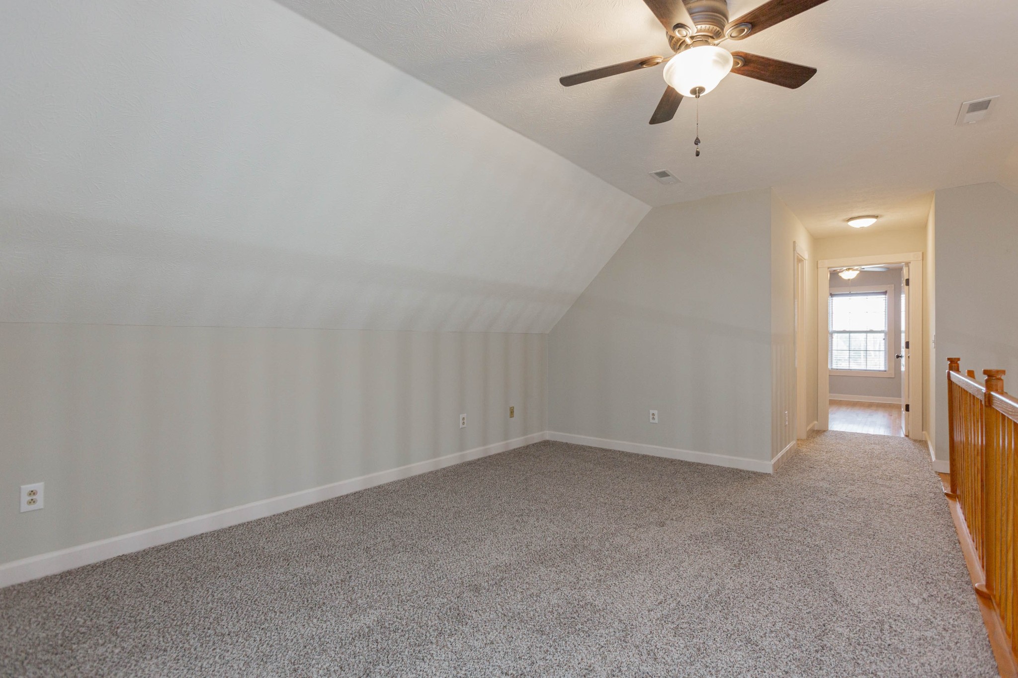 122 Boiling Springs Road Portland, TN 37148 - Photo 22 of 27 an empty room with a chandelier fan and windows
