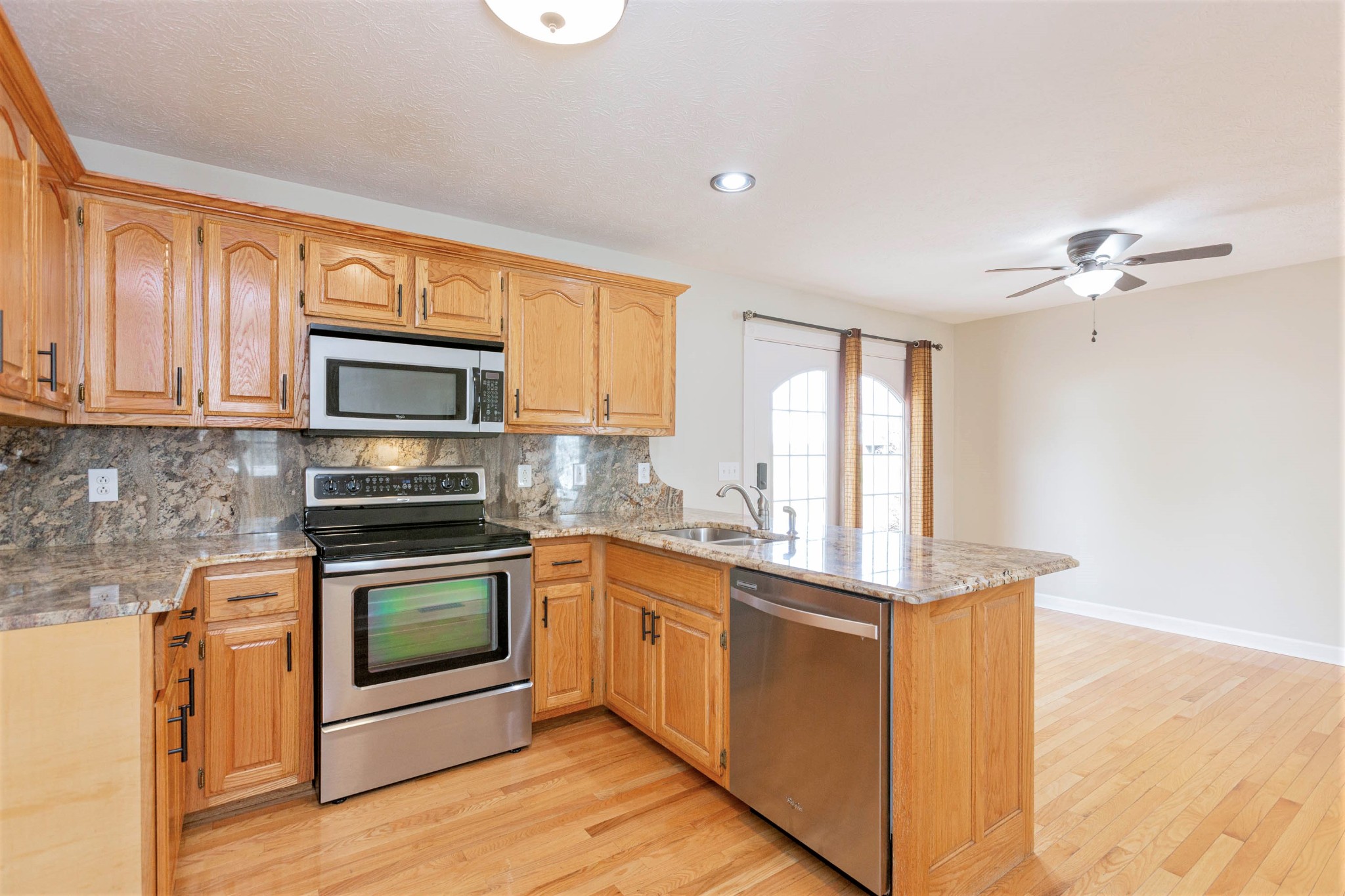 122 Boiling Springs Road Portland, TN 37148 - Photo 5 of 27 a kitchen with stainless steel appliances granite countertop a stove a sink and a microwave