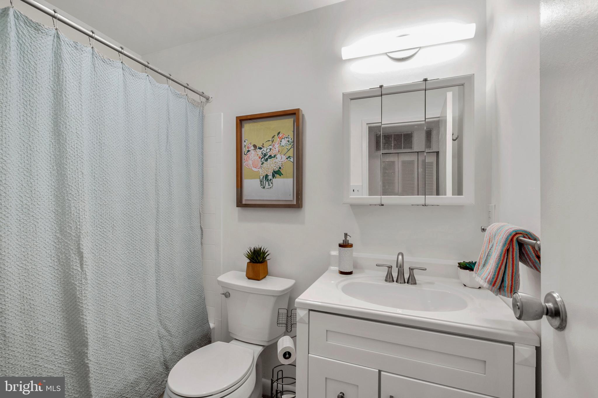 6137 Edsall Road, Unit F Alexandria, VA 22304 - Photo 12 of 36 a bathroom with a toilet sink and mirror