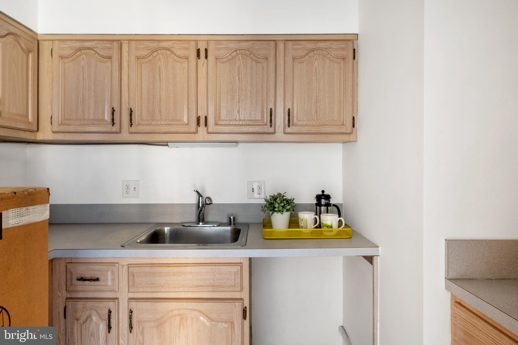 6137 Edsall Road, Unit F Alexandria, VA 22304 - Photo 13 of 36 a kitchen with a sink and cabinets
