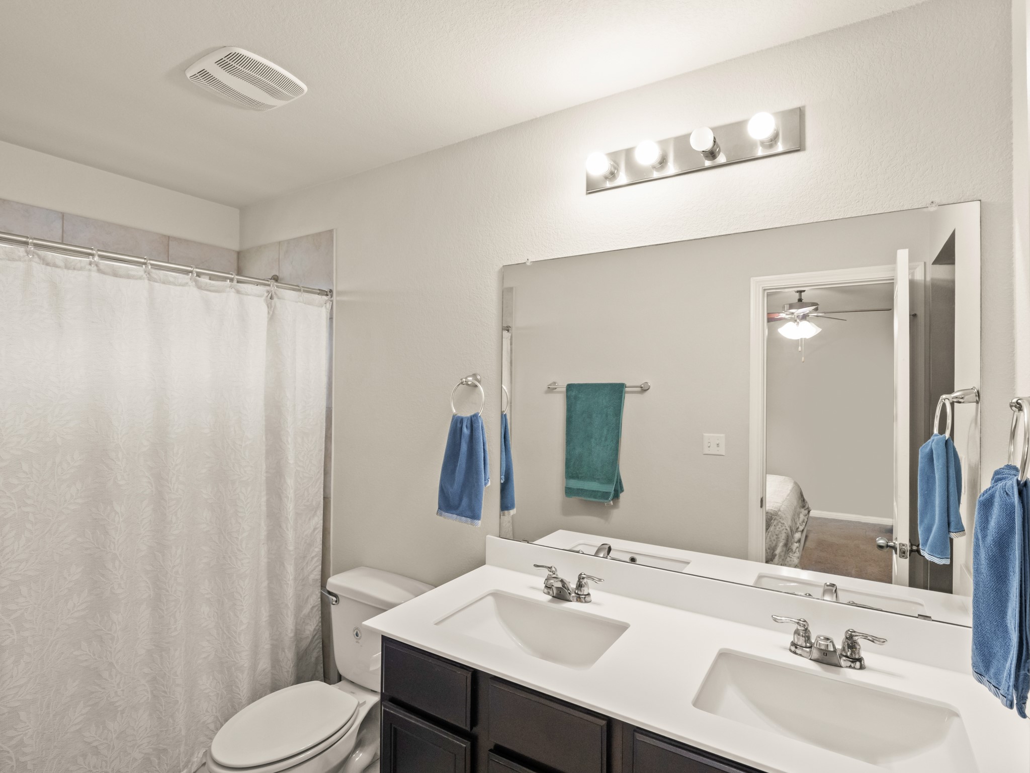 574 Nautical Loop Kyle, TX 78640 - Photo 13 of 23 A pristine bathroom features a convenient double vanity and a clean shower area.