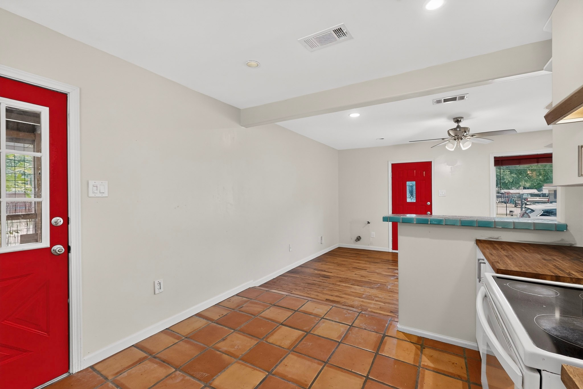 4711 Alf Avenue Austin, TX 78721 - Photo 15 of 34 Bold red entryways punctuate this living area, offering a warm welcome.