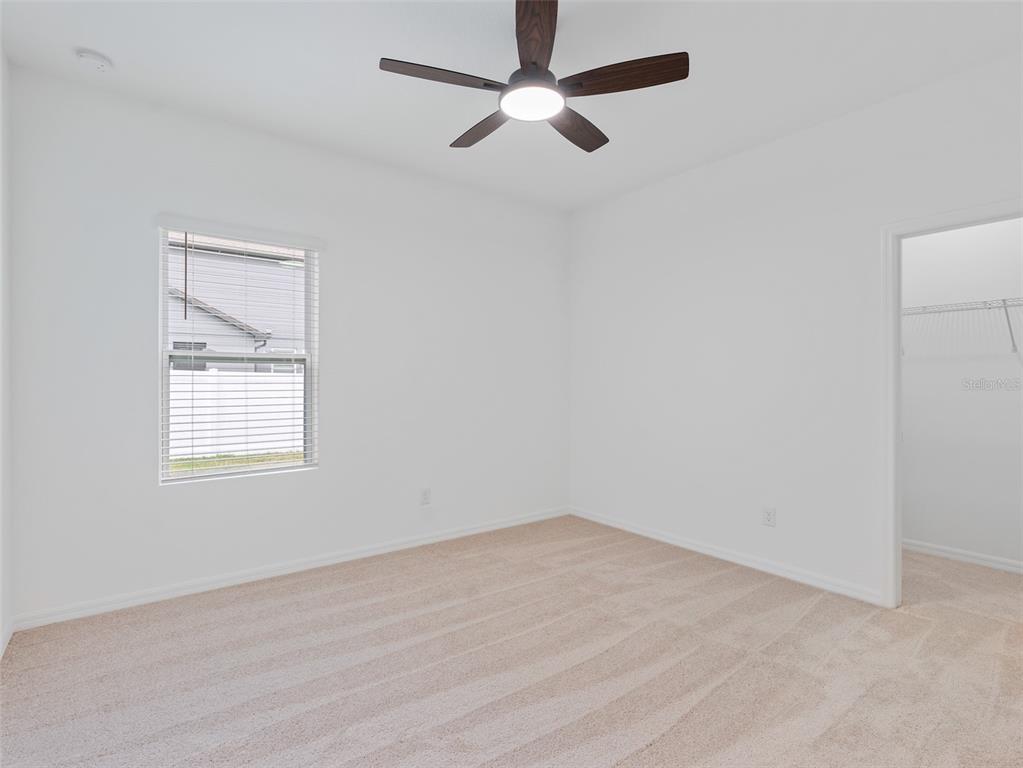 1122 Pearl Tree Road Deltona, FL 32725 - Photo 15 of 30 an empty room with a window and a fan