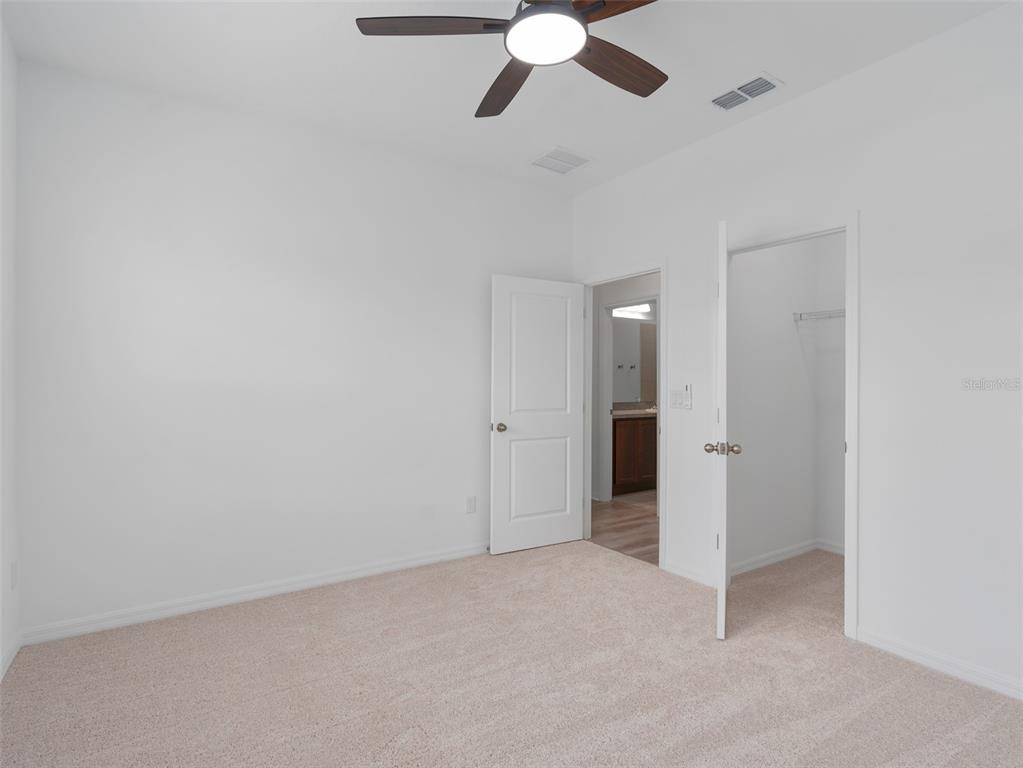 1122 Pearl Tree Road Deltona, FL 32725 - Photo 19 of 30 an empty room with closet and windows