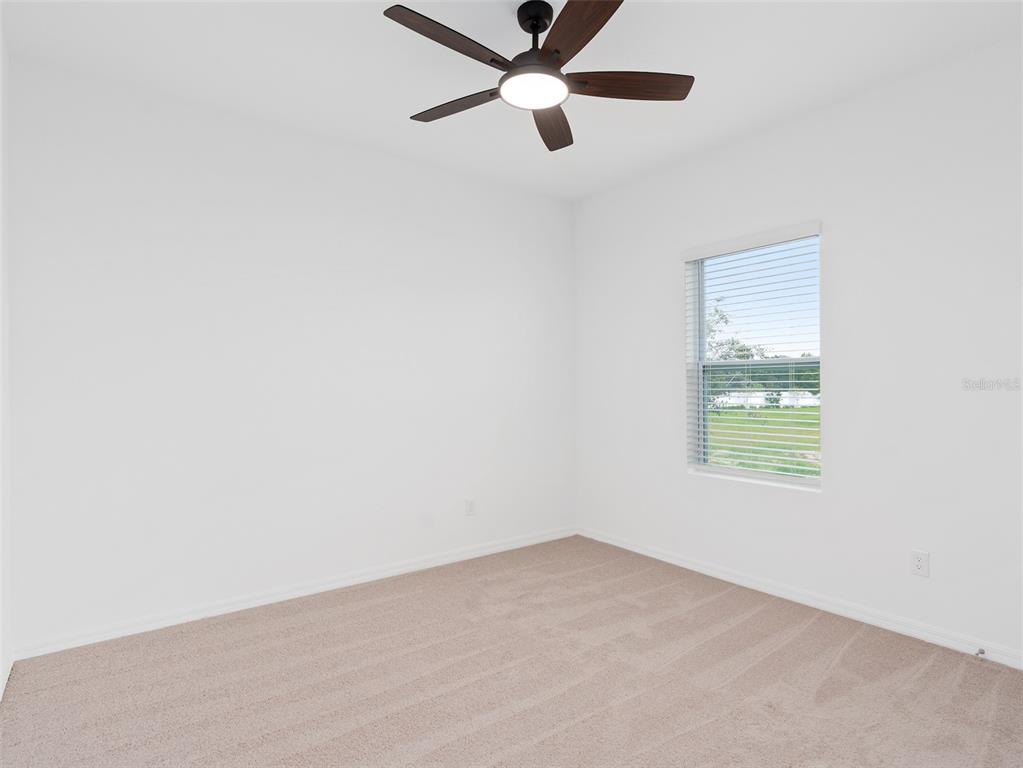 1122 Pearl Tree Road Deltona, FL 32725 - Photo 20 of 30 an empty room with a window and a fan