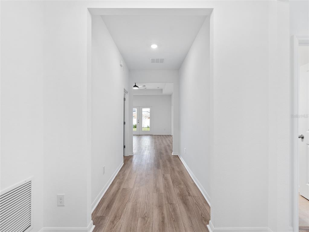 1122 Pearl Tree Road Deltona, FL 32725 - Photo 3 of 30 a view of a hallway with wooden floor
