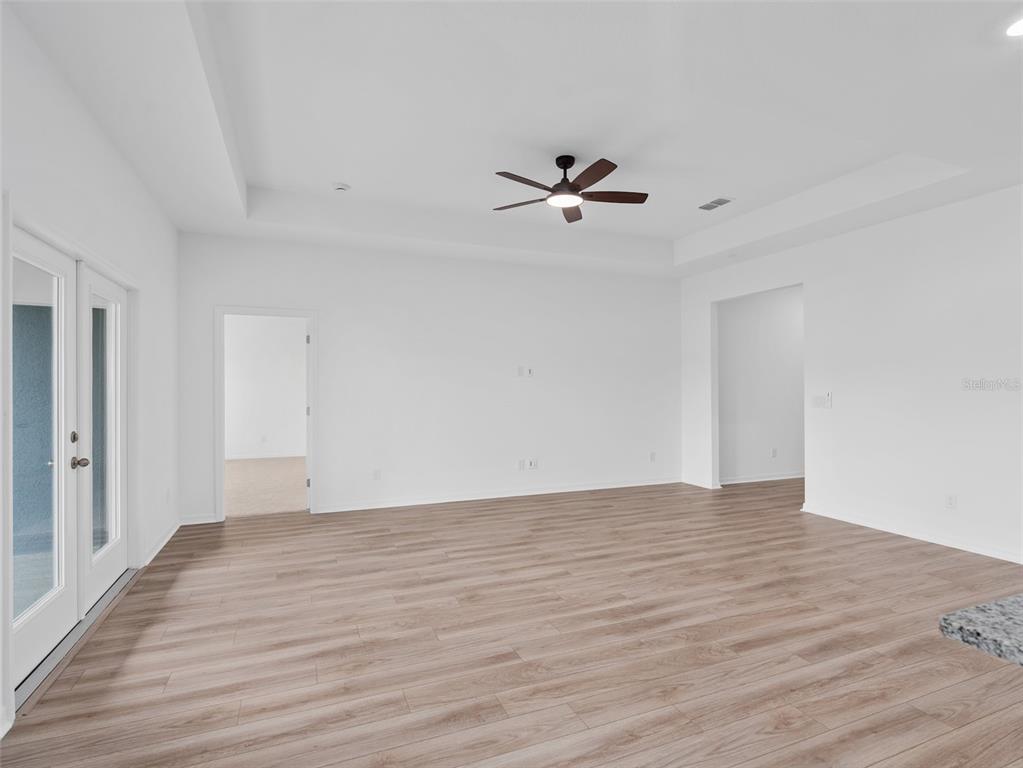 1122 Pearl Tree Road Deltona, FL 32725 - Photo 8 of 30 a view of room with hardwood floor and ceiling fan