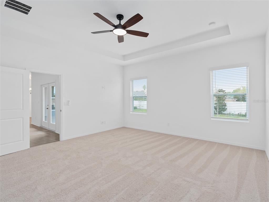 1122 Pearl Tree Road Deltona, FL 32725 - Photo 10 of 30 wooden floor in an empty room with a window