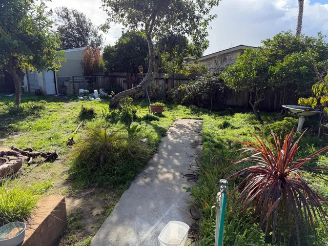 a view of a house with sitting area and garden