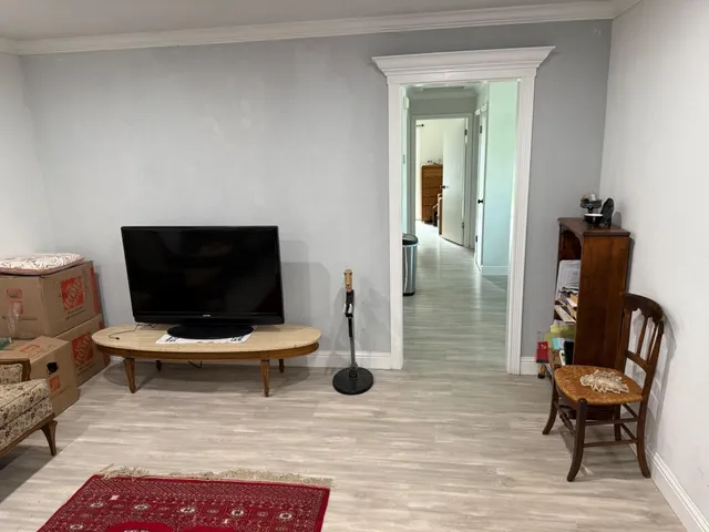 a living room with patio furniture and a flat screen tv