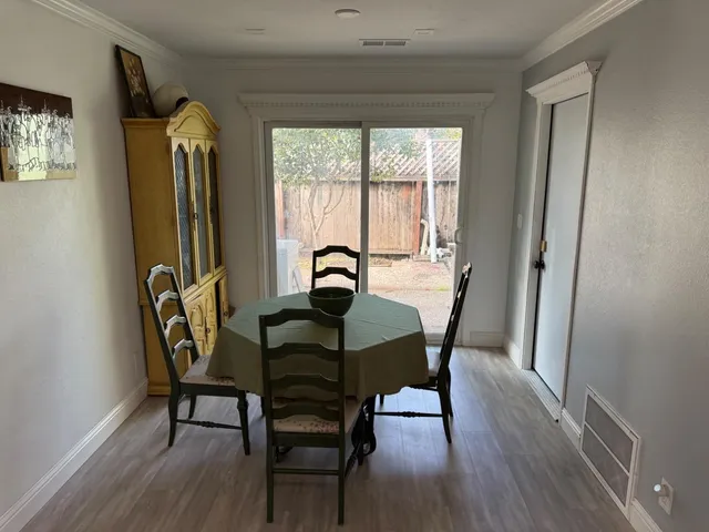 a view of a dining room with furniture and window