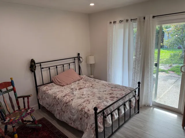 a bedroom with a bed and a window