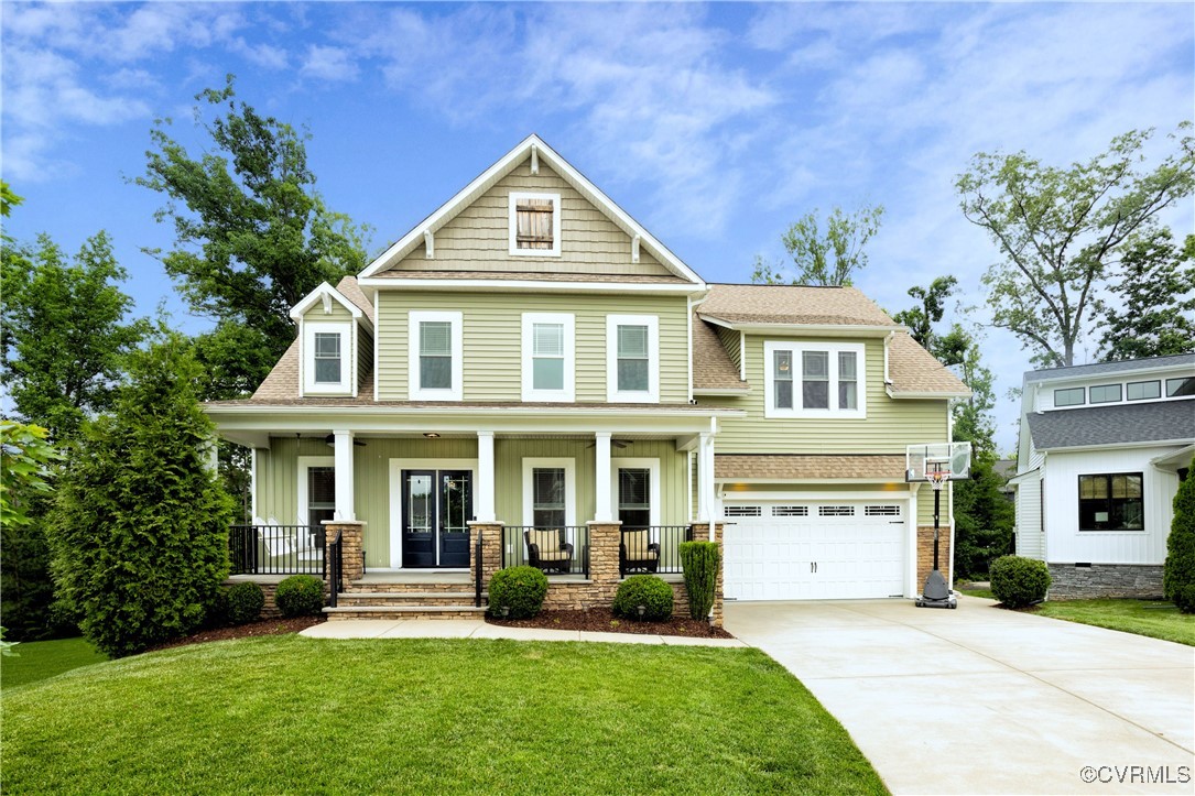 Craftsman-style house with concrete driveway, boar