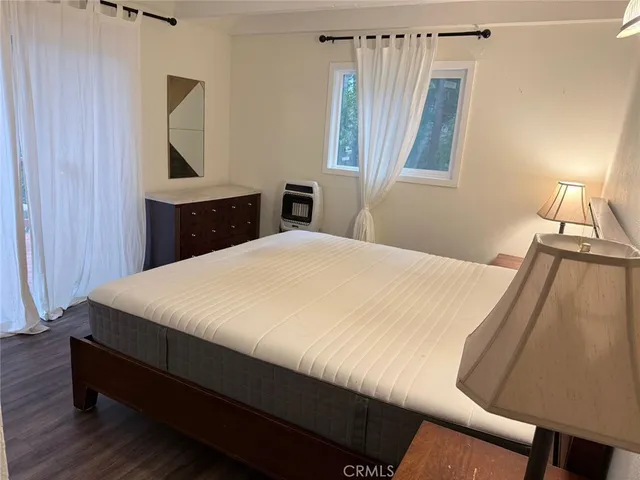 a bed room with a bed and a window