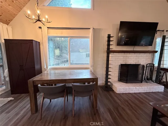 a view of furniture and kitchen with wooden floor