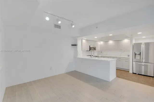 an empty room with windows and closet