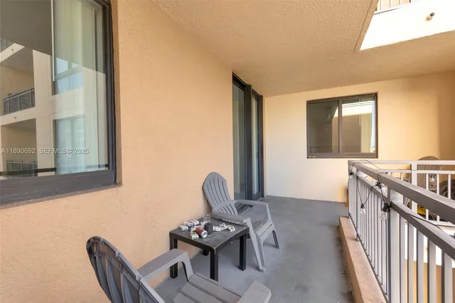 a view of a patio with table and chairs and potted plants