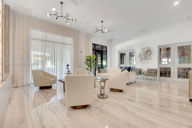 a living room with furniture and a chandelier