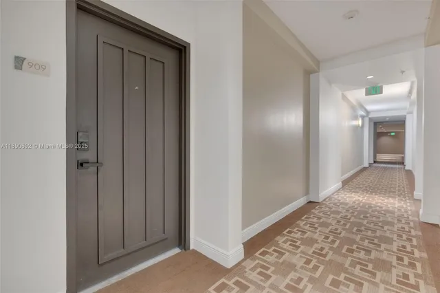 a view of hallway with a front door and stairs
