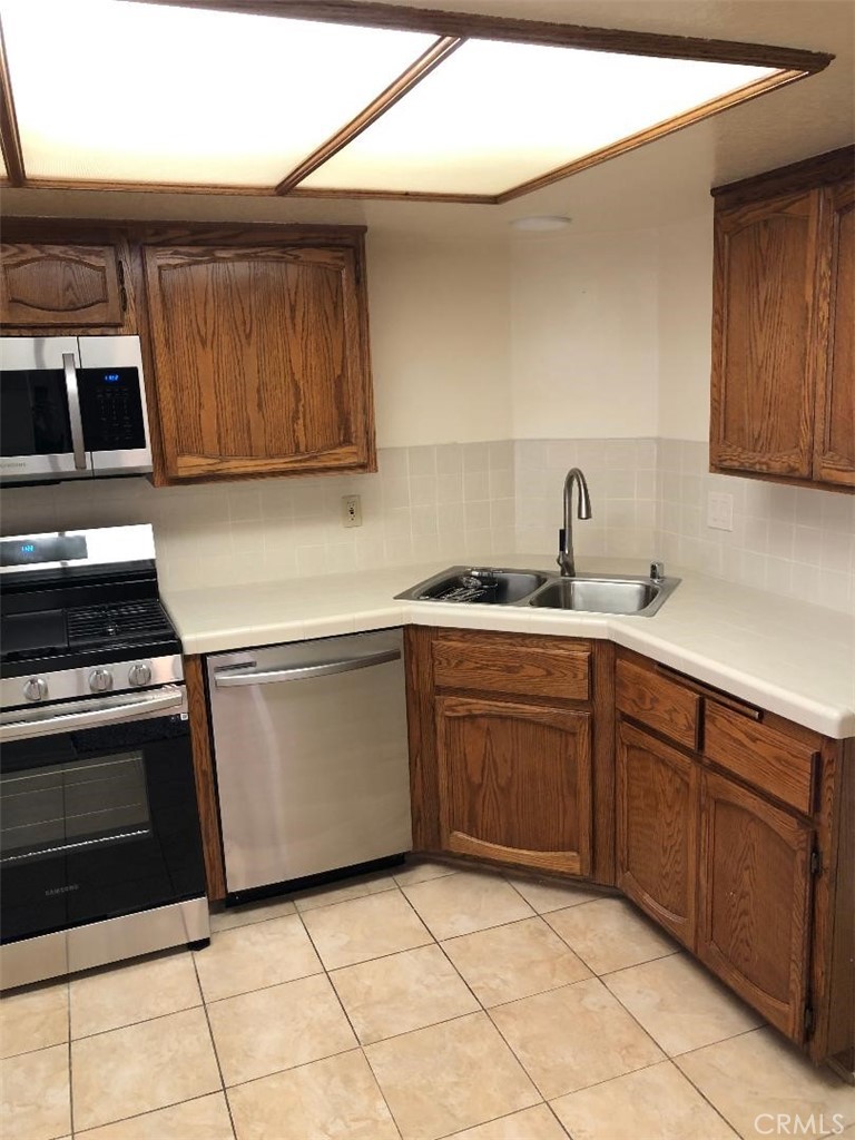 2248 Del Mar Road, Unit 3 Montrose, CA 91020 - Photo 4 of 12 a kitchen with a sink stove and cabinets