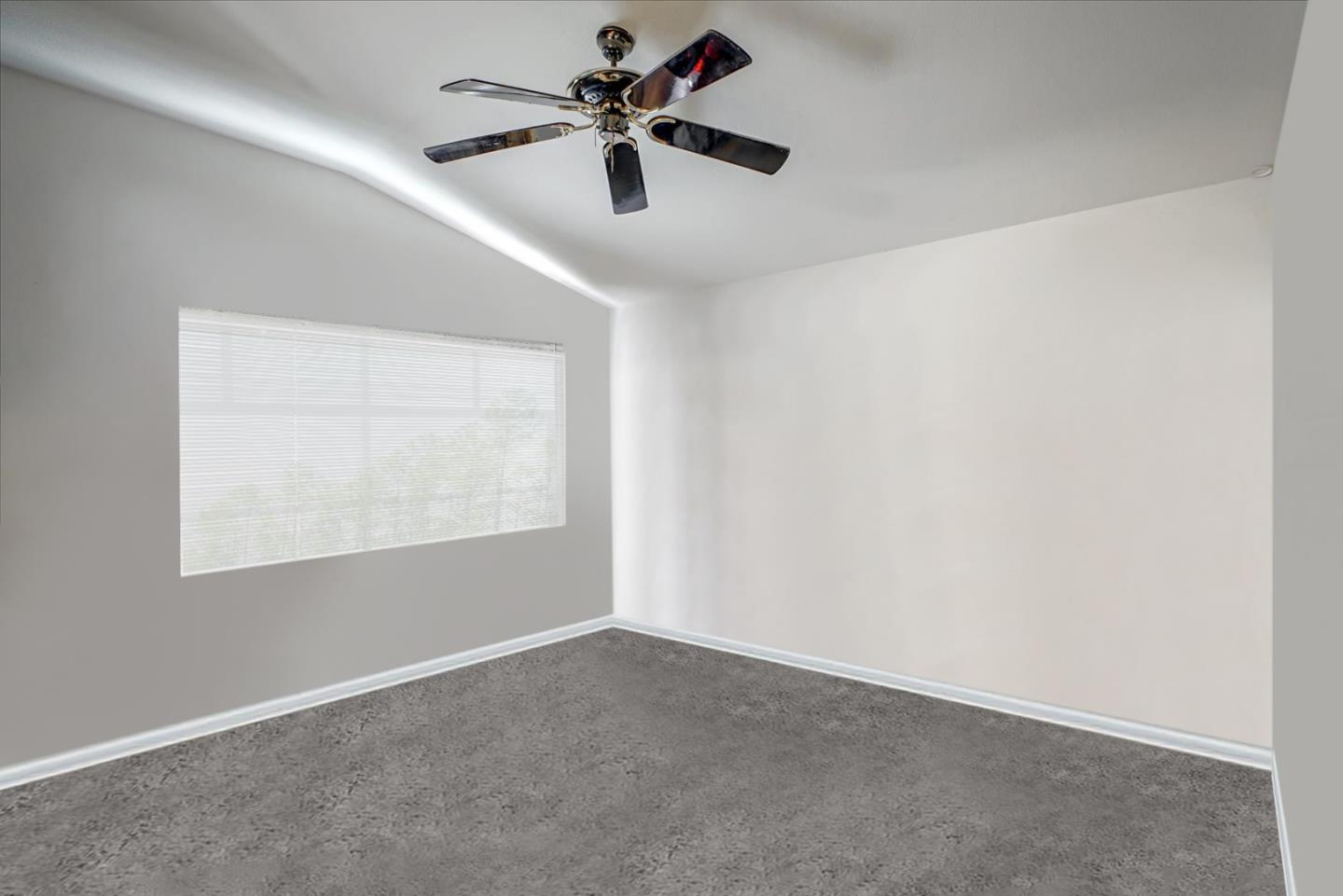 2113 Manhattan Way Modesto, CA 95358 - Photo 11 of 17 an empty room with a window and a fan
