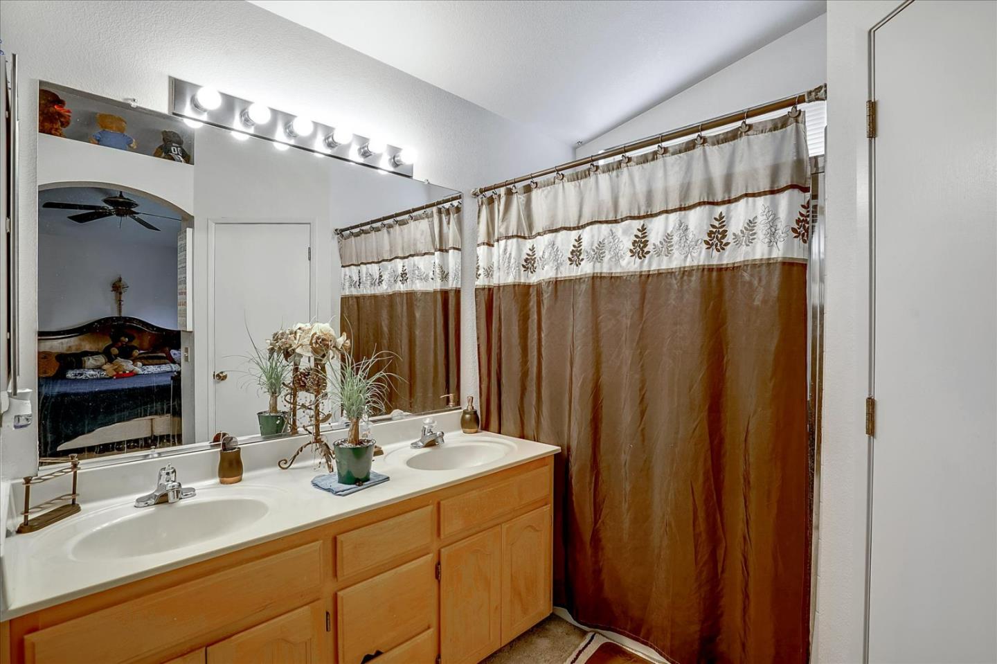 2113 Manhattan Way Modesto, CA 95358 - Photo 15 of 17 a bathroom with a double vanity sink and a mirror