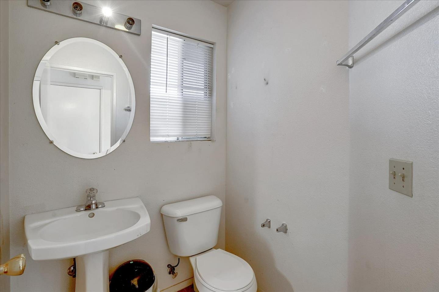 2113 Manhattan Way Modesto, CA 95358 - Photo 16 of 17 a bathroom with a sink mirror and toilet