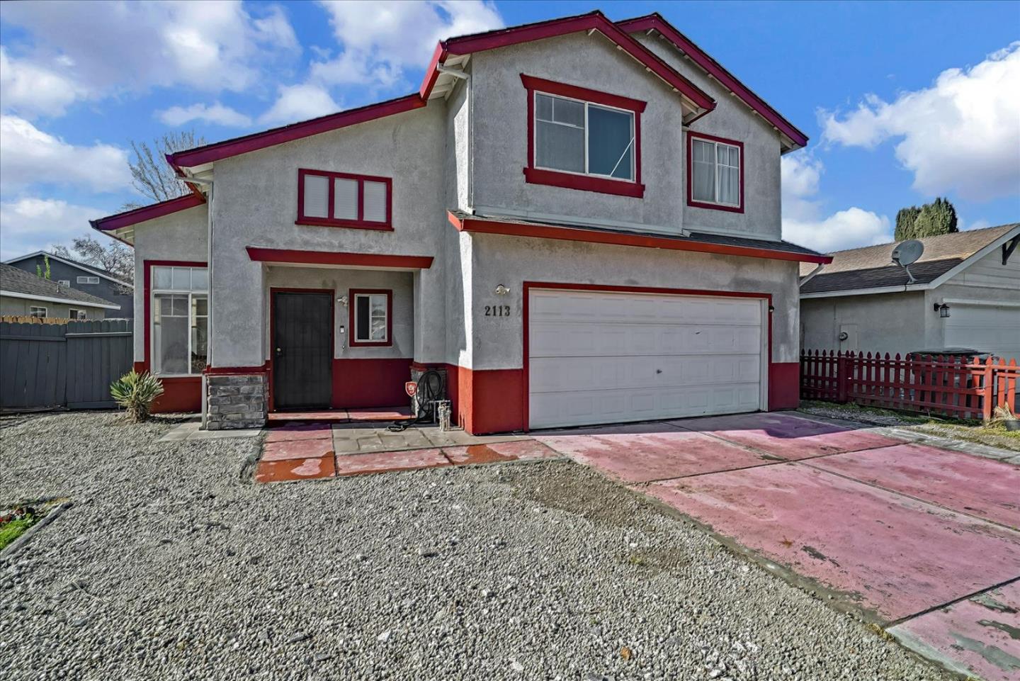 2113 Manhattan Way Modesto, CA 95358 - Photo 2 of 17 a front view of a house with a yard