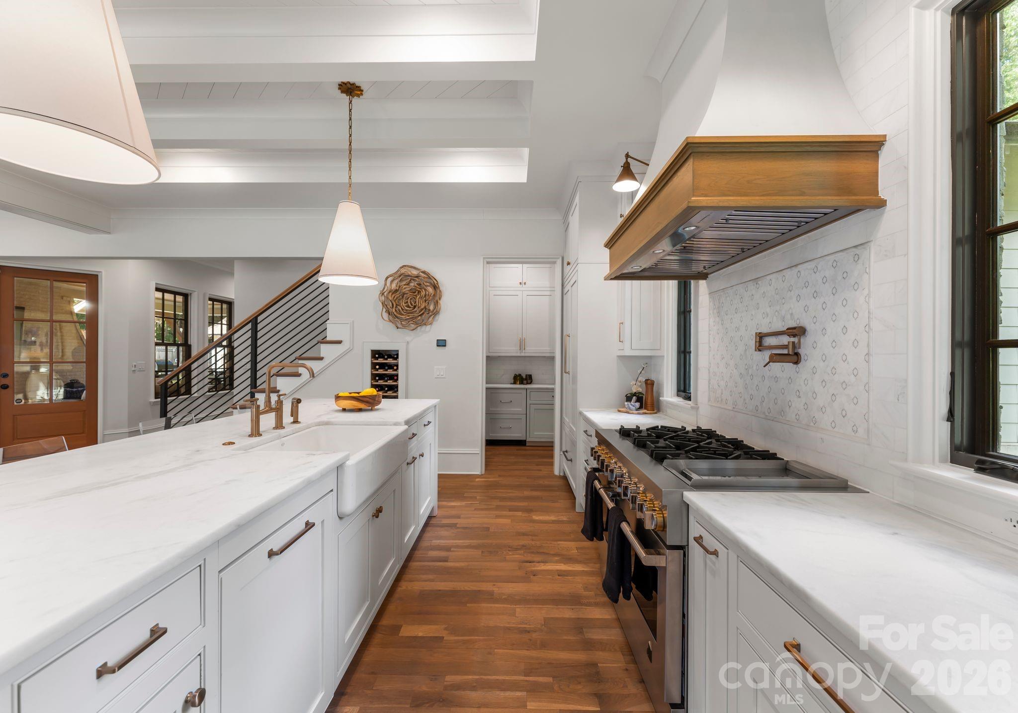 5625 Timber Lane Charlotte, NC 28270 - Photo 19 of 48 a large kitchen with a stove and a wooden floors