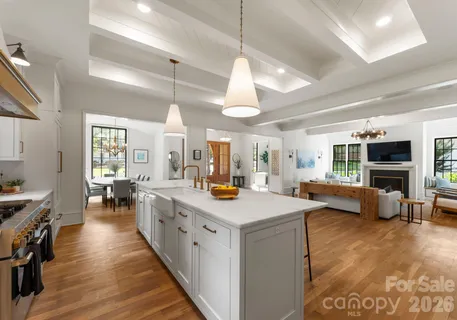 a view of a kitchen counter top space with furniture and wooden floor