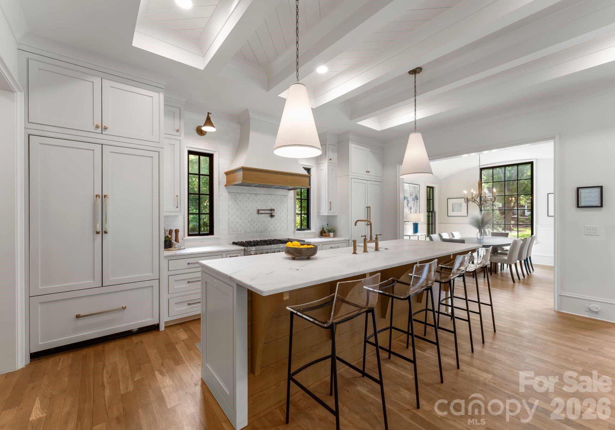 5625 Timber Lane Charlotte, NC 28270 - Photo 22 of 48 a kitchen with kitchen island a stove a table and chairs in it