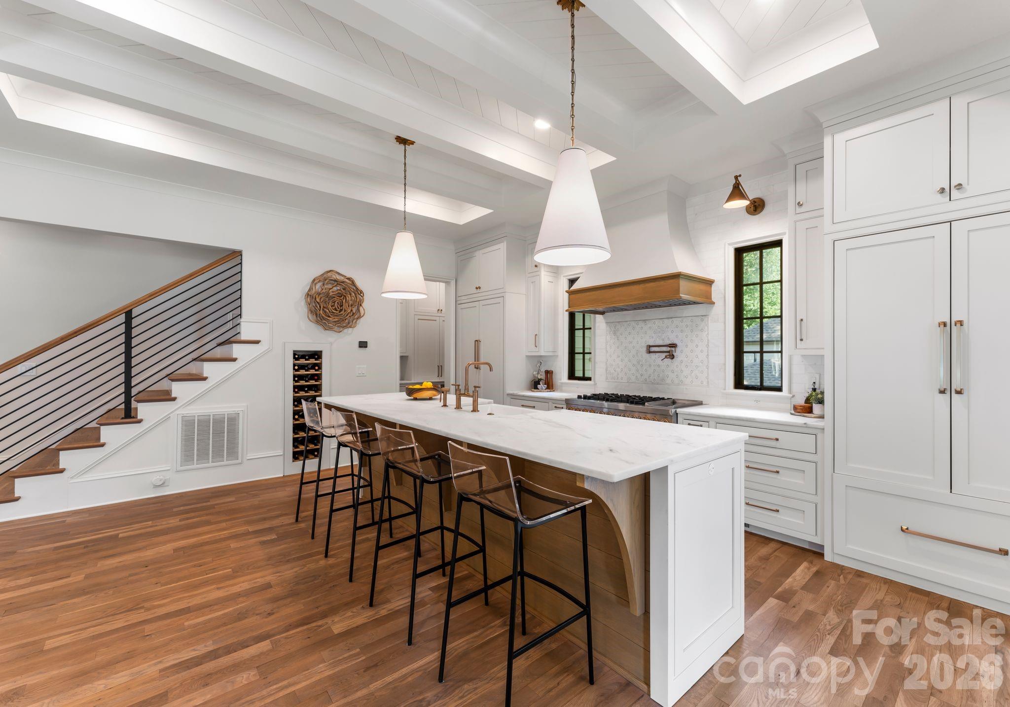 5625 Timber Lane Charlotte, NC 28270 - Photo 24 of 48 a kitchen with a table chairs and wooden floor