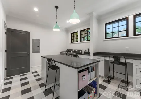 a kitchen with a sink a refrigerator and cabinets