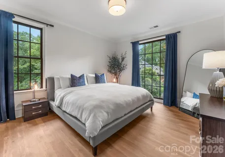 a bedroom with a large bed and a window