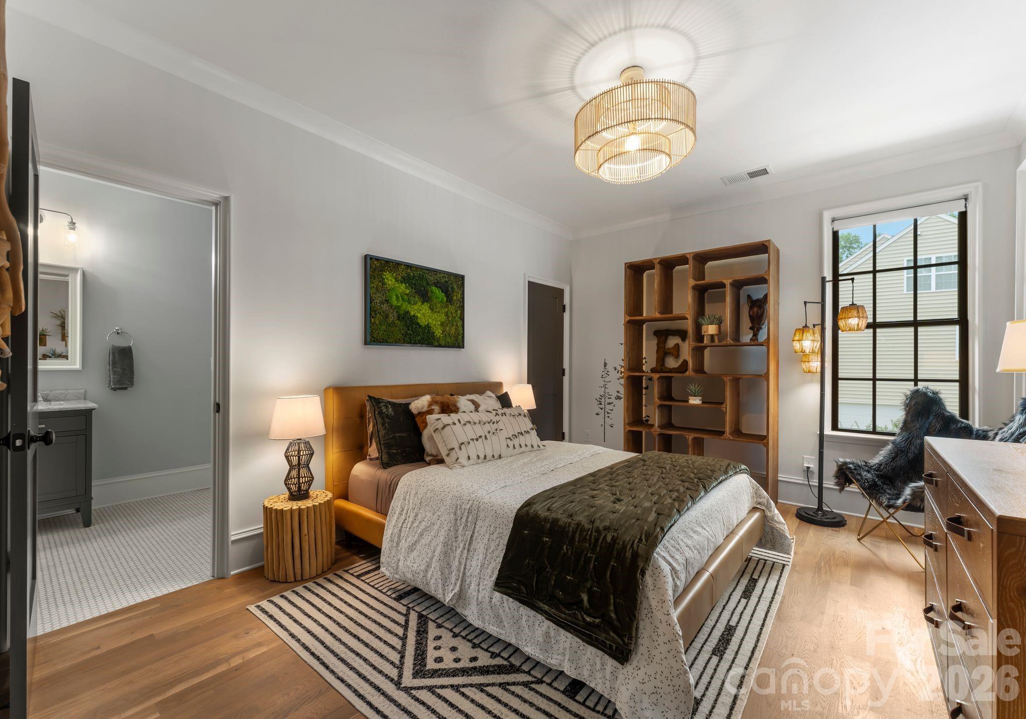 5625 Timber Lane Charlotte, NC 28270 - Photo 36 of 48 a bedroom with a bed and a chandelier