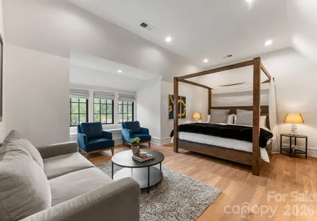 a bedroom with furniture and wooden floor