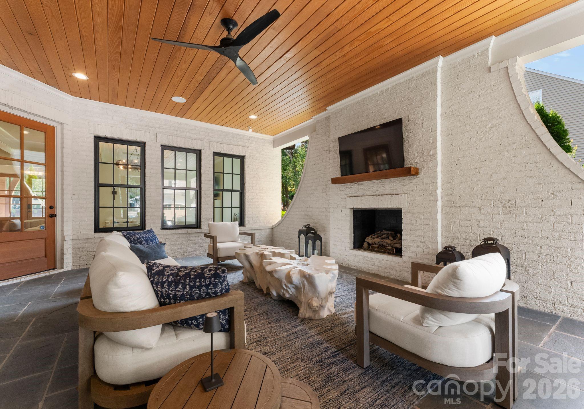 5625 Timber Lane Charlotte, NC 28270 - Photo 44 of 48 a living room with furniture a flat screen tv and a fireplace